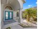 Inviting entryway with double teal doors and arched detail at 7162 Benson St, Englewood, FL 34224