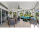 Bright sunroom, with seating and dining areas, overlooking the garden at 7162 Benson St, Englewood, FL 34224