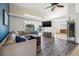 Open concept living area with L-shaped sofa and views to kitchen and backyard at 7162 Benson St, Englewood, FL 34224