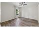 Simple bedroom with wood-look flooring and large window at 7162 Benson St, Englewood, FL 34224