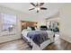 Main bedroom with wood-look flooring and access to the patio at 7162 Benson St, Englewood, FL 34224