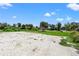 Large backyard with gravel area and tropical trees at 7162 Benson St, Englewood, FL 34224