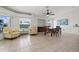 Bright dining room with wood table and chairs, ceiling fan, and tiled floor at 7162 Benson St, Englewood, FL 34224