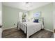 Bedroom with metal bed frame and wood-look flooring at 7162 Benson St, Englewood, FL 34224