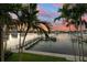 Stunning sunset view over the water with boats and palm trees at 158 Brightwater Dr # 1, Clearwater Beach, FL 33767