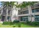 Waterfront building with private patios and lush landscaping at 158 Brightwater Dr # 1, Clearwater Beach, FL 33767