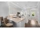 Modern kitchen features white cabinets, quartz countertops, and a breakfast bar at 158 Brightwater Dr # 1, Clearwater Beach, FL 33767