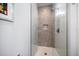 Walk-in shower with stone tile and glass enclosure at 158 Brightwater Dr # 1, Clearwater Beach, FL 33767