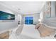 Comfortable bedroom with a queen-size bed and access to a balcony at 158 Brightwater Dr # 1, Clearwater Beach, FL 33767