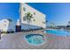 Community spa and pool with plenty of seating at 158 Brightwater Dr # 1, Clearwater Beach, FL 33767