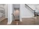 Elegant staircase with a modern metal railing leading to the lower level at 158 Brightwater Dr # 1, Clearwater Beach, FL 33767