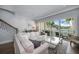 Bright living room with water views, featuring a comfy sofa and large windows at 158 Brightwater Dr # 1, Clearwater Beach, FL 33767