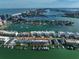 Aerial view of waterfront property with boat slips and city skyline in background at 158 Brightwater Dr # 1, Clearwater Beach, FL 33767