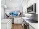 Modern kitchen with stainless steel appliances and white cabinetry at 158 Brightwater Dr # 1, Clearwater Beach, FL 33767