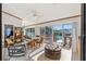 Bright sunroom with pool view and seating area for relaxing at 366 6Th N Ave, Tierra Verde, FL 33715
