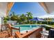 Inviting pool area with a deck and blue umbrella, perfect for outdoor entertaining at 366 6Th N Ave, Tierra Verde, FL 33715