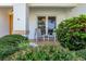 Inviting front porch with seating area and lush landscaping at 366 6Th N Ave, Tierra Verde, FL 33715