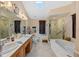Elegant bathroom with double vanity, soaking tub, and walk-in shower at 366 6Th N Ave, Tierra Verde, FL 33715