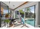 Bright home gym with sliding glass doors opening to the pool area at 366 6Th N Ave, Tierra Verde, FL 33715