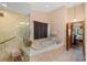 Bathroom with a large soaking tub and walk-in shower at 366 6Th N Ave, Tierra Verde, FL 33715