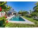 Relaxing backyard oasis with a sparkling pool and patio seating area at 366 6Th N Ave, Tierra Verde, FL 33715