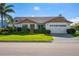 Charming single story home with a two-car garage and lush landscaping at 366 6Th N Ave, Tierra Verde, FL 33715