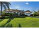 Single-story home with attached garage, well-maintained lawn, and attractive landscaping at 366 6Th N Ave, Tierra Verde, FL 33715