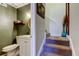 Small bathroom with white vanity and toilet, adjacent to carpeted stairs at 7200 Ulmerton Rd # F2, Largo, FL 33771