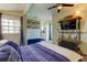 Bright bedroom with large window, blue bedding, and adjacent bathroom view at 7200 Ulmerton Rd # F2, Largo, FL 33771