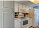 White kitchen with stove, oven, microwave and cabinets at 7200 Ulmerton Rd # F2, Largo, FL 33771