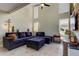 Spacious living room with sectional sofa, high ceilings, and a rustic wood accent wall at 7200 Ulmerton Rd # F2, Largo, FL 33771