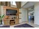 Open living room with sectional sofa, high ceilings, and a rustic wood accent wall at 7200 Ulmerton Rd # F2, Largo, FL 33771