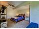 Comfortable bedroom with a rustic wooden bed frame, blue bedding, and a ceiling fan at 7200 Ulmerton Rd # F2, Largo, FL 33771