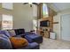 Bright living room with sectional sofa, high ceilings, and a rustic wood accent wall at 7200 Ulmerton Rd # F2, Largo, FL 33771
