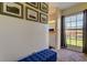 Bedroom sitting area with blue bench and large window overlooking green space at 7200 Ulmerton Rd # F2, Largo, FL 33771