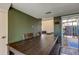 Dark wood dining table with seating for four, view to living room and patio at 7200 Ulmerton Rd # F2, Largo, FL 33771