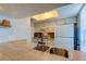 Kitchen sink and countertop with tan tile, white cabinets and appliances at 7200 Ulmerton Rd # F2, Largo, FL 33771