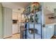 Stainless steel kitchen shelving unit with mixer and other appliances at 7200 Ulmerton Rd # F2, Largo, FL 33771