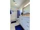 Updated bathroom with white vanity, tile shower, and blue accents at 7200 Ulmerton Rd # F2, Largo, FL 33771