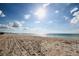 Scenic beach view with clear sky and tire tracks on the sand at 7200 Ulmerton Rd # F2, Largo, FL 33771