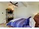 Charming bedroom with TV stand, ceiling fan, and blue bedding at 7200 Ulmerton Rd # F2, Largo, FL 33771
