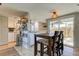 Eat-in kitchen with white cabinets, breakfast bar, and sliding glass door to patio at 7200 Ulmerton Rd # F2, Largo, FL 33771