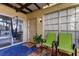 Relaxing patio with two green chairs, a hammock, and view into the home at 7200 Ulmerton Rd # F2, Largo, FL 33771