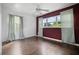 Bedroom with dark wood floors, a ceiling fan, and burgundy walls at 5575 6Th N Ave, St Petersburg, FL 33710