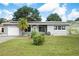 Gray house with solar panels, white garage door, and landscaped lawn at 5575 6Th N Ave, St Petersburg, FL 33710