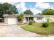 Gray house with solar panels, white garage door, and landscaped lawn at 5575 6Th N Ave, St Petersburg, FL 33710