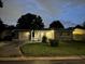 Attractive gray house with solar panels, well-lit at night at 5575 6Th N Ave, St Petersburg, FL 33710