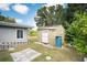 Light green shed with a rain barrel in the backyard at 5575 6Th N Ave, St Petersburg, FL 33710