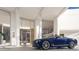 Luxury building exterior with porte cochere and a blue convertible parked in front at 5701 Bowen Daniel Dr. # 1 Villa, Tampa, FL 33616