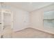 Bright bedroom with neutral walls and carpet, featuring a closet and access to another room at 5552 Logan Cave Ave, Wimauma, FL 33598